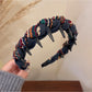 Top view of Gifty knitted fabric wrapped headband highlighting fabric pattern