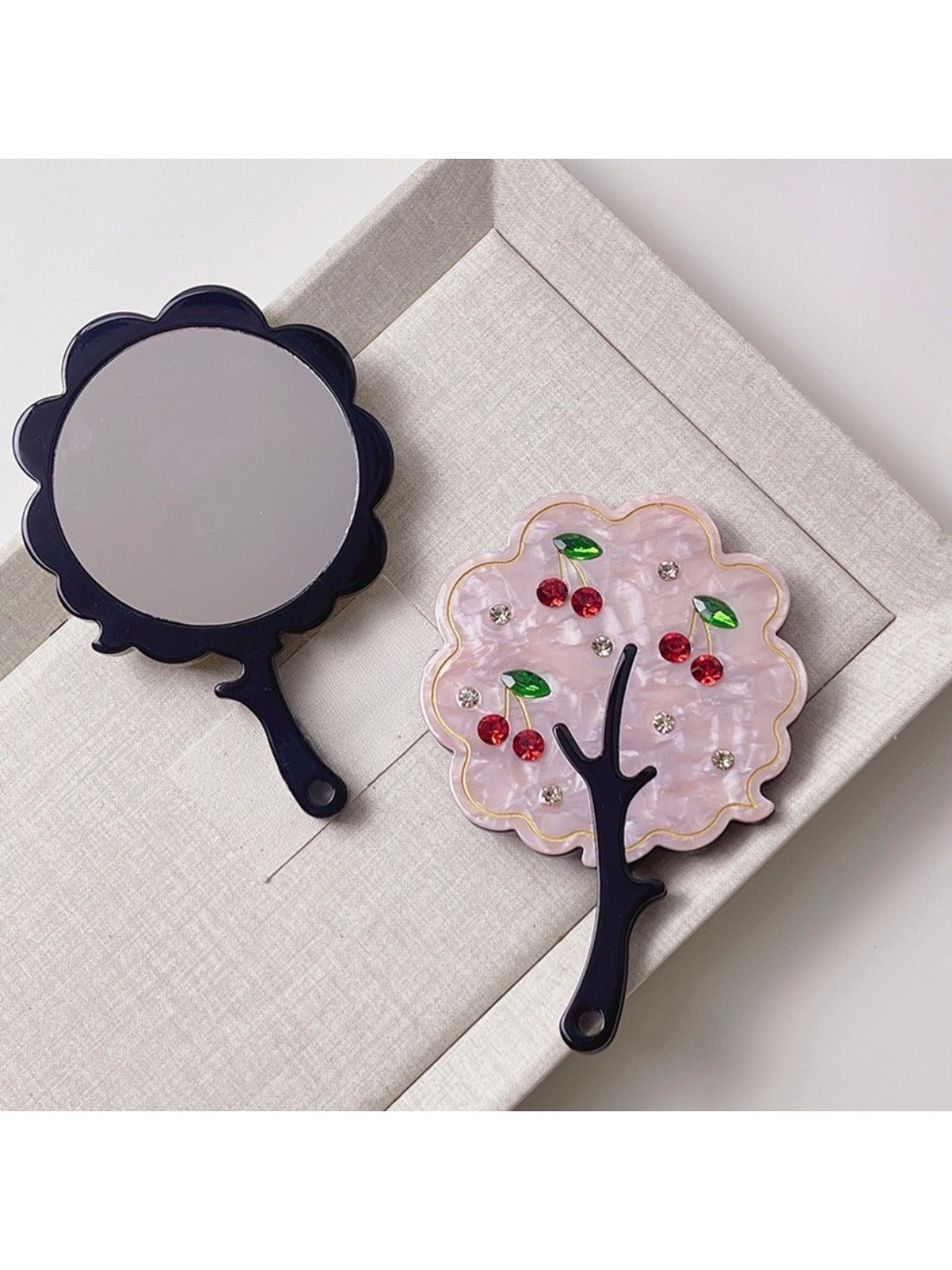 Mirroray tree-shaped handheld mirror reflecting a bright room interior