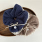 White lace scrunchie with bow displayed on a white background