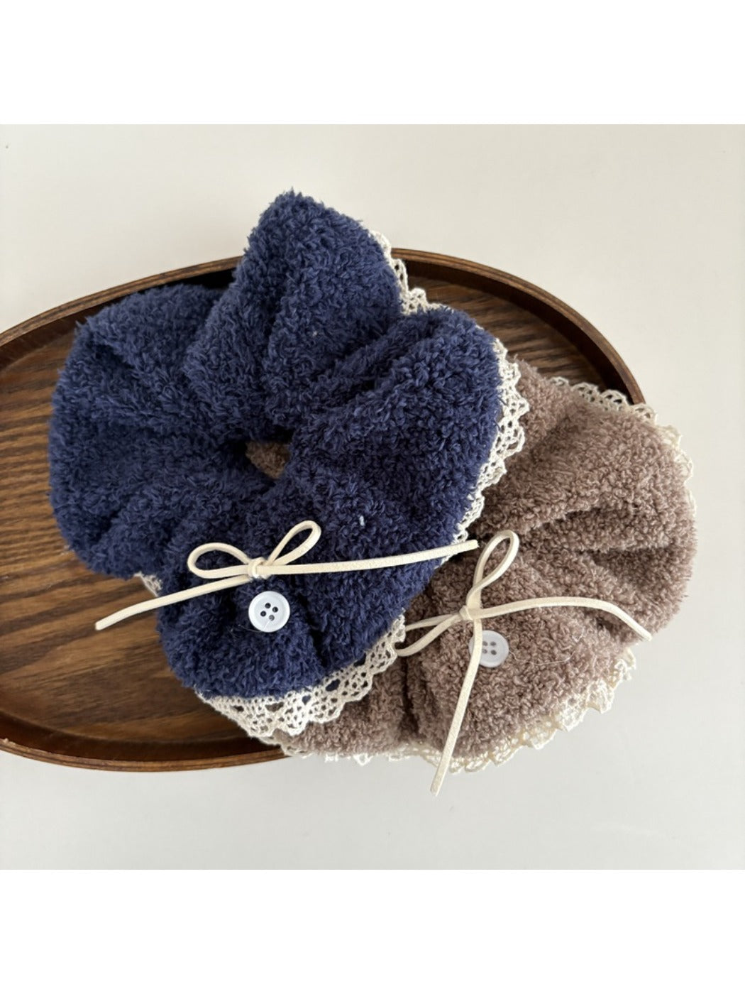 White lace scrunchie with bow displayed on a white background