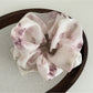 Gifty satin scrunchie wrapped around wrist as a stylish accessory