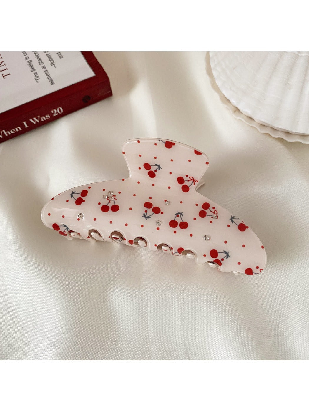Beau printed half moon hair claw clip on neutral surface with natural lighting