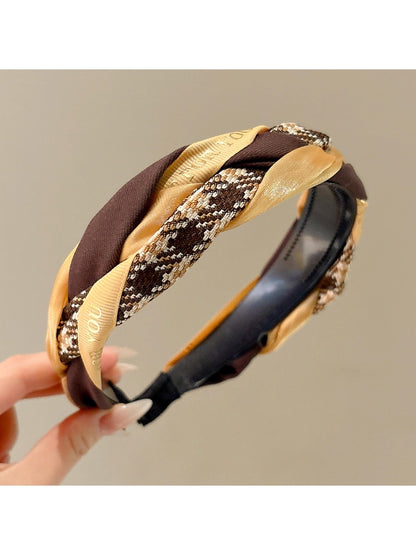 Gifty twist headband displayed flat highlighting the twisted design