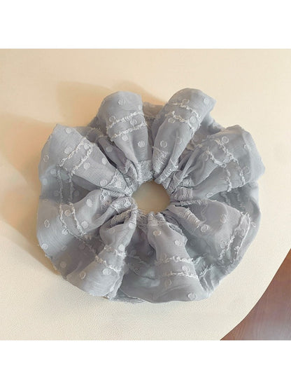 Gifty solid color ruffled scrunchie in soft fabric, styled on a white background