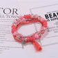 Lovra multi-row beaded bracelet with tassels on a rustic wooden surface