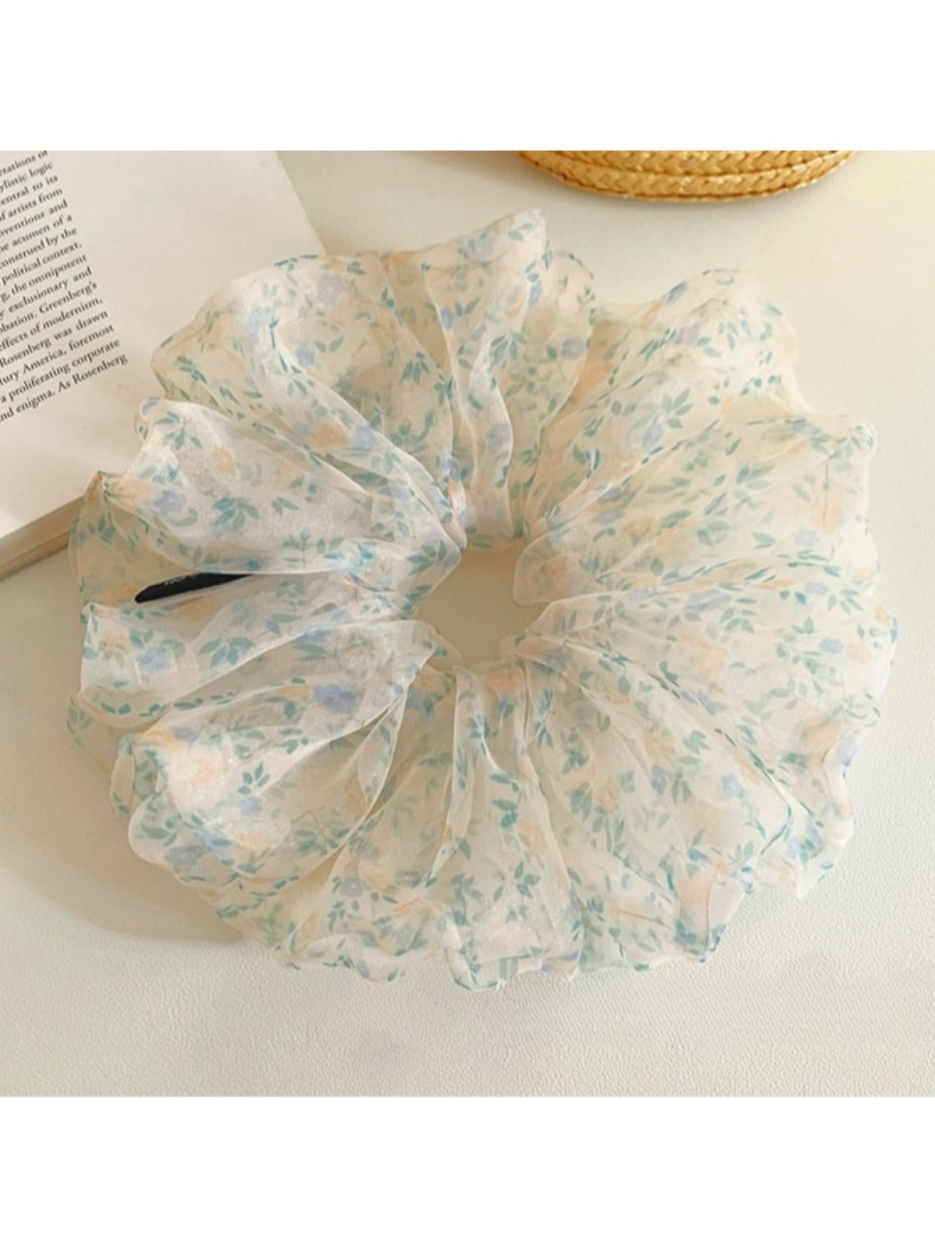 Side view of large green tulle scrunchie with tiny floral details