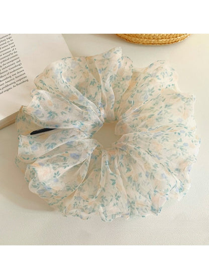 Side view of large green tulle scrunchie with tiny floral details