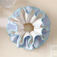 Minimalist blue double layer scrunchie on a white background