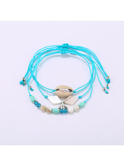 Lovra mermaid tail bracelet worn on wrist showing bead and charm details