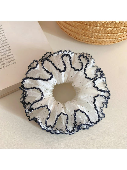 Four tier ruffled scrunchie styled in a ponytail on a model