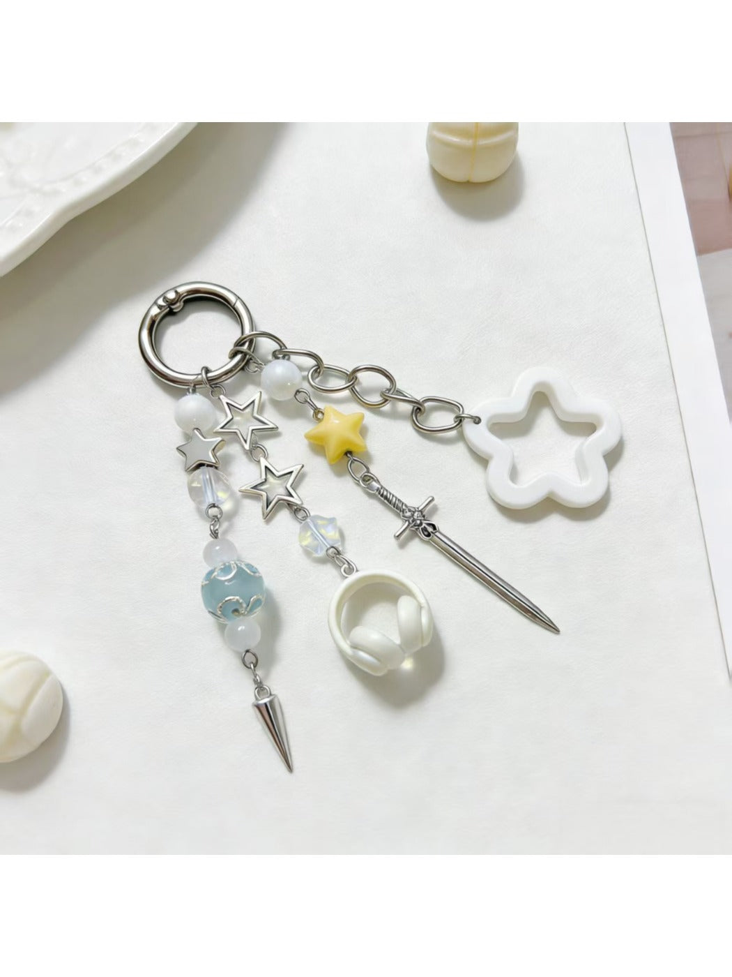 Delicate gold star charm keychain held in hand highlighting its size and detail