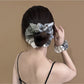 Close-up of Gifty scrunchie showing patchwork plaid fabric details