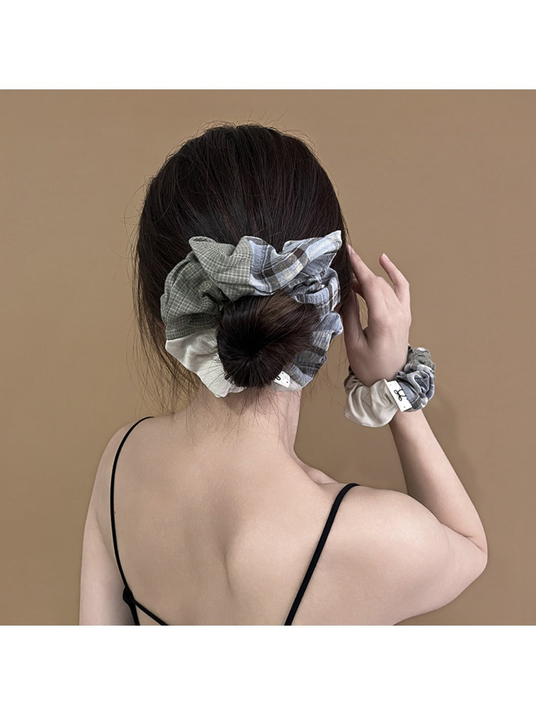 Close-up of Gifty scrunchie showing patchwork plaid fabric details