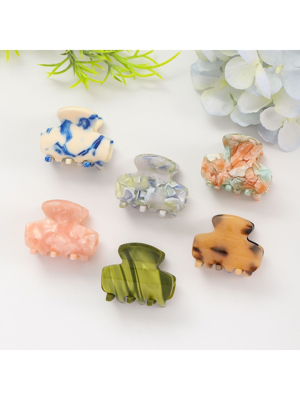 Beau fresh acetate hair clip held in hand displaying size and shape