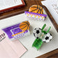 Beau claw clip shaped like a soccer ball held in hand showing size and grip