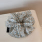 Gifty elegant daisy print scrunchie packaged in a clear plastic box