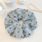 Close-up of Gifty polka dot ruched scrunchie in black and white fabric