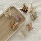 Close-up of Beau butterfly claw clip showing light pastel colors and wing details