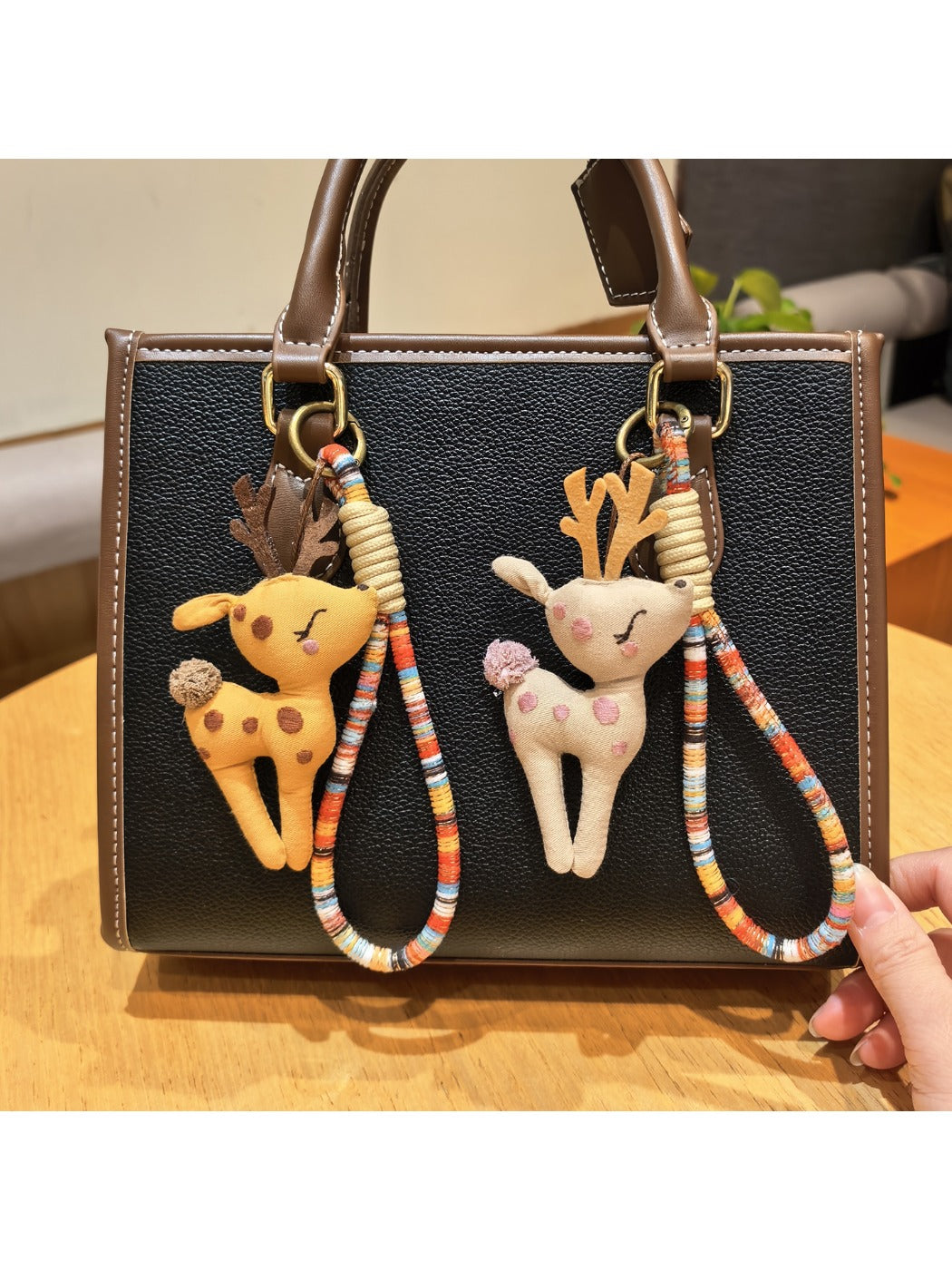 Close-up of a stylish deer charm keychain with intricate antler design