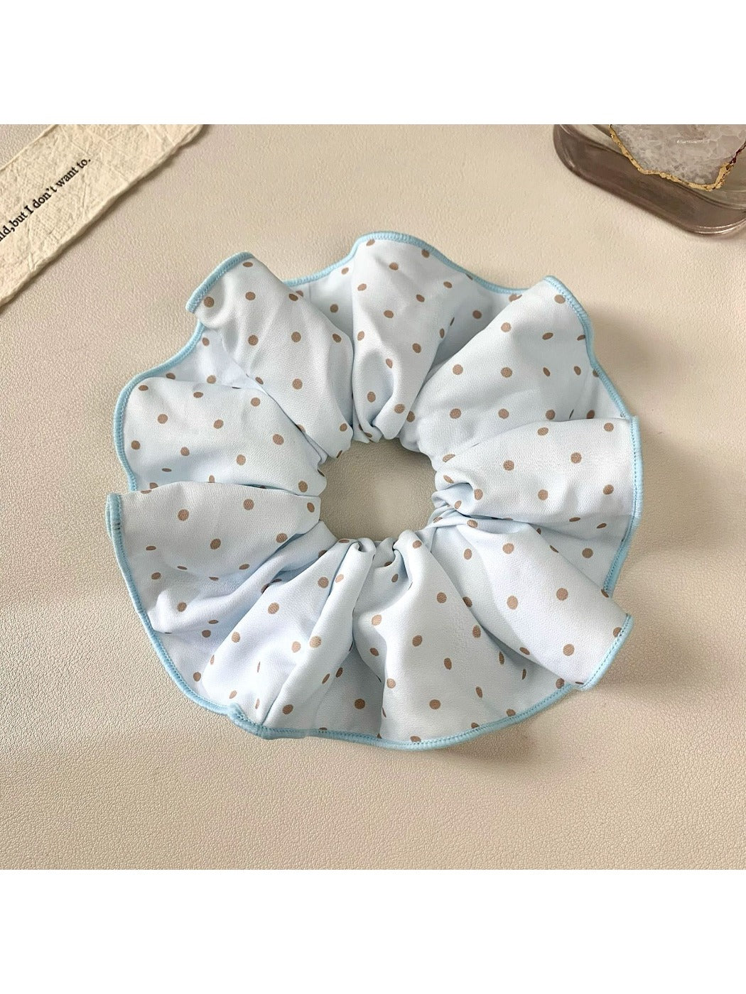 Gifty polka dot scrunchie displayed on a wooden surface