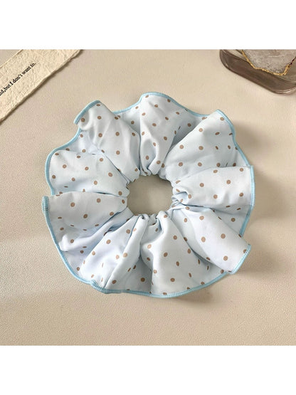 Gifty polka dot scrunchie displayed on a wooden surface