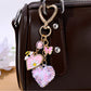 Heart shaped keychain hanging from a silver keyring with rhinestone embellishments