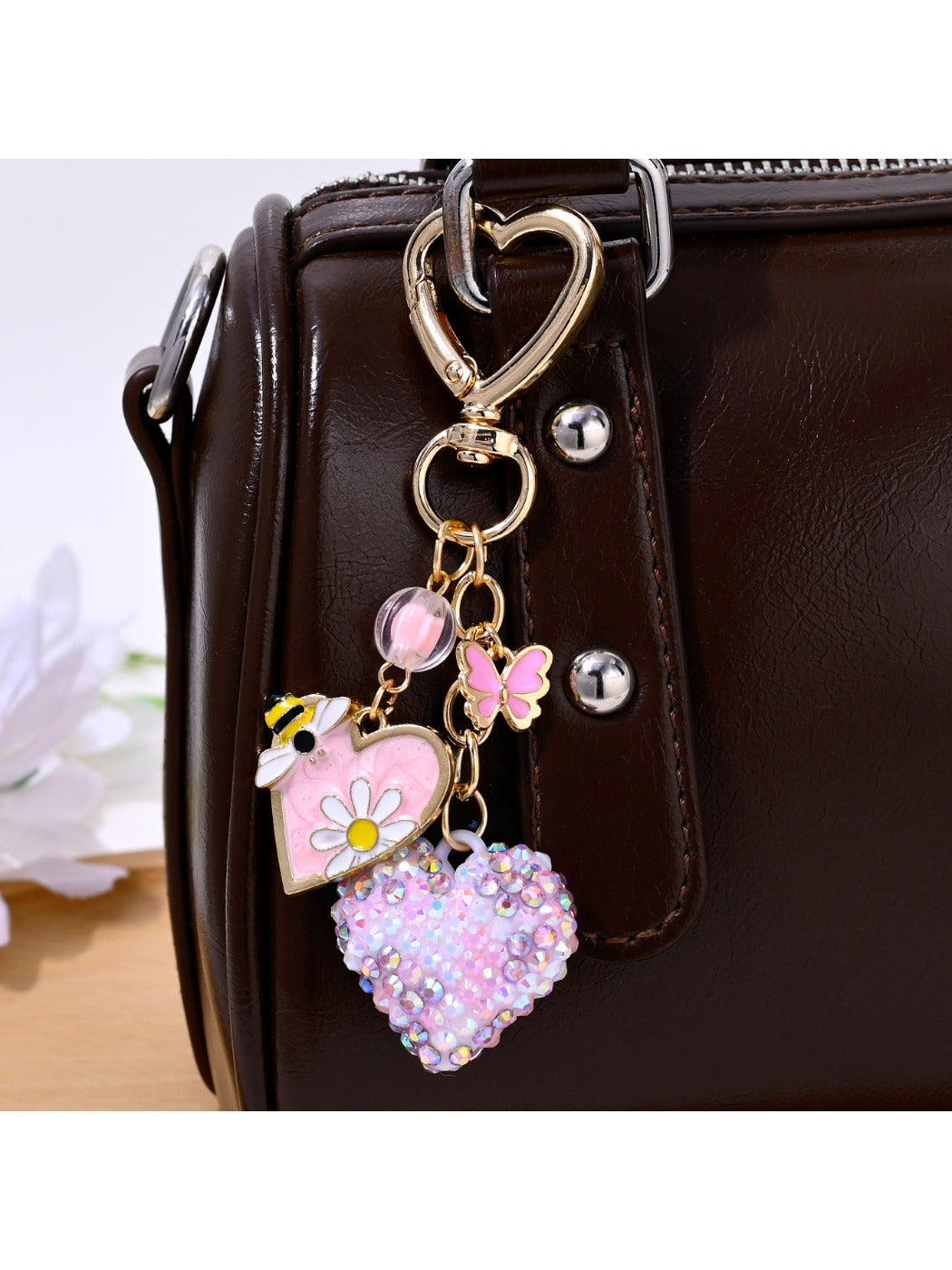 Heart shaped keychain hanging from a silver keyring with rhinestone embellishments