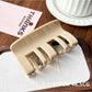 Beau plastic square claw clip displayed alongside hair strands