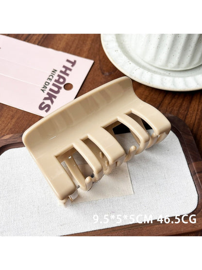 Beau plastic square claw clip displayed alongside hair strands