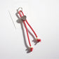 Rope heart keychain with vibrant colors against a plain background