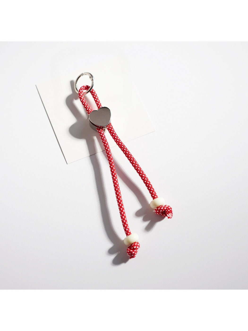 Rope heart keychain with vibrant colors against a plain background