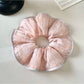 Close-up of pink striped fabric texture on hair scrunchie
