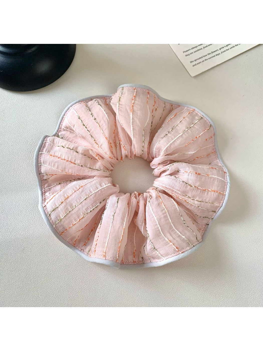 Close-up of pink striped fabric texture on hair scrunchie