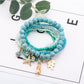 Lovra stackable bracelet with ocean charm displayed on a wooden surface