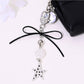 Keypus bow-shaped keychain with star and heart charms on a silver ring