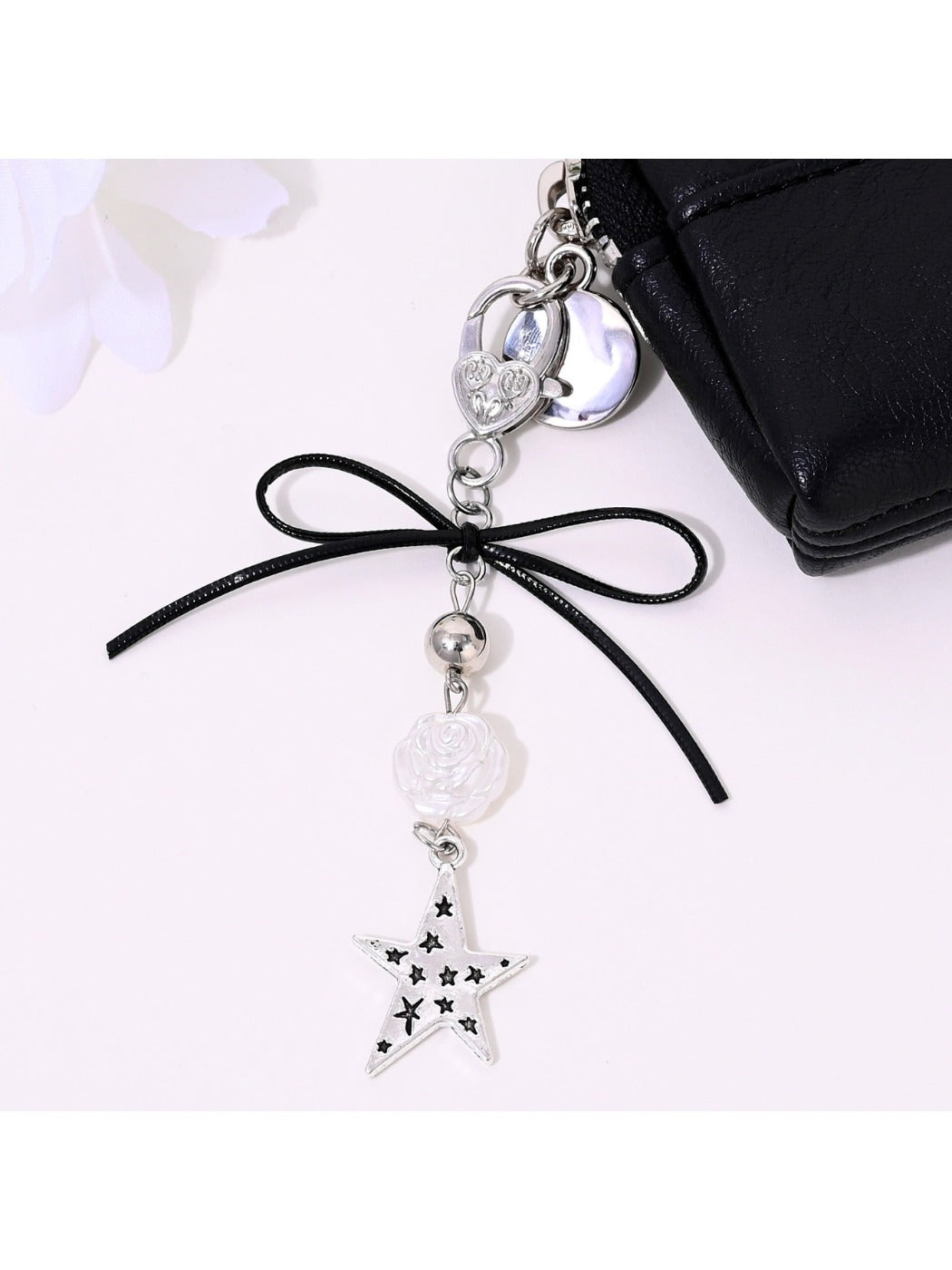 Keypus bow-shaped keychain with star and heart charms on a silver ring