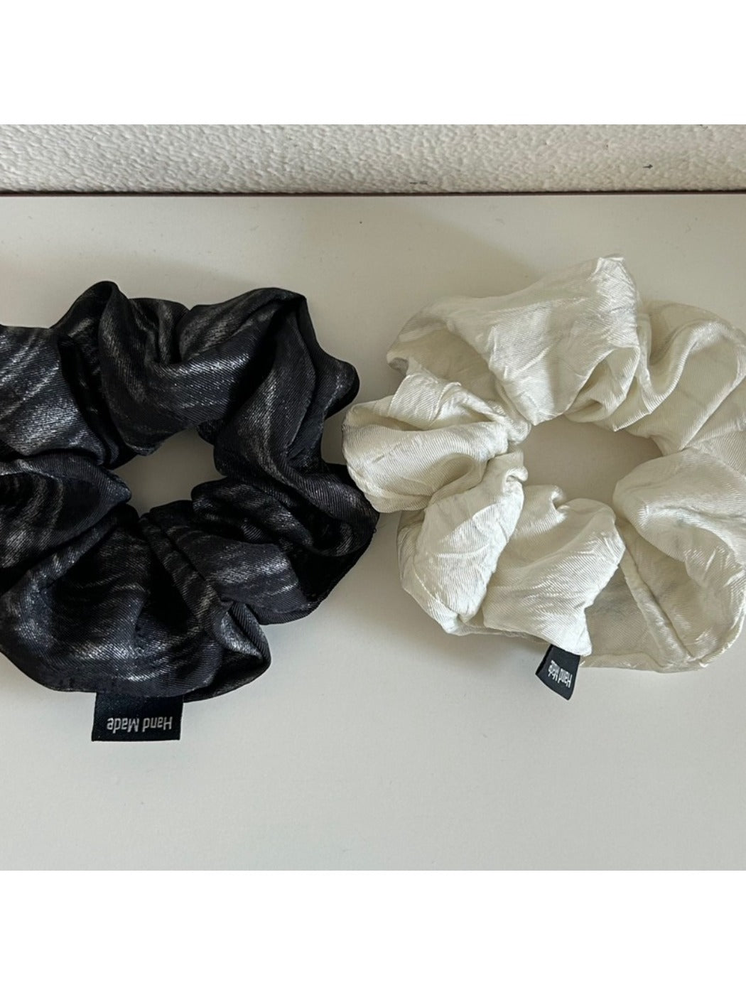 Side view of vintage pleated fabric scrunchie highlighting fabric folds