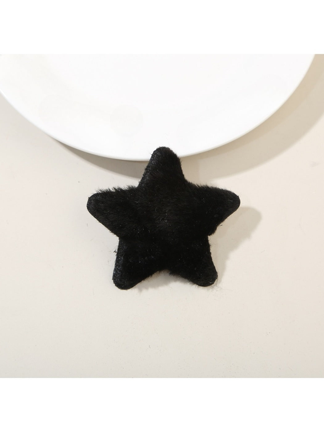Top view of plush star hair clip highlighting its symmetrical five-point design