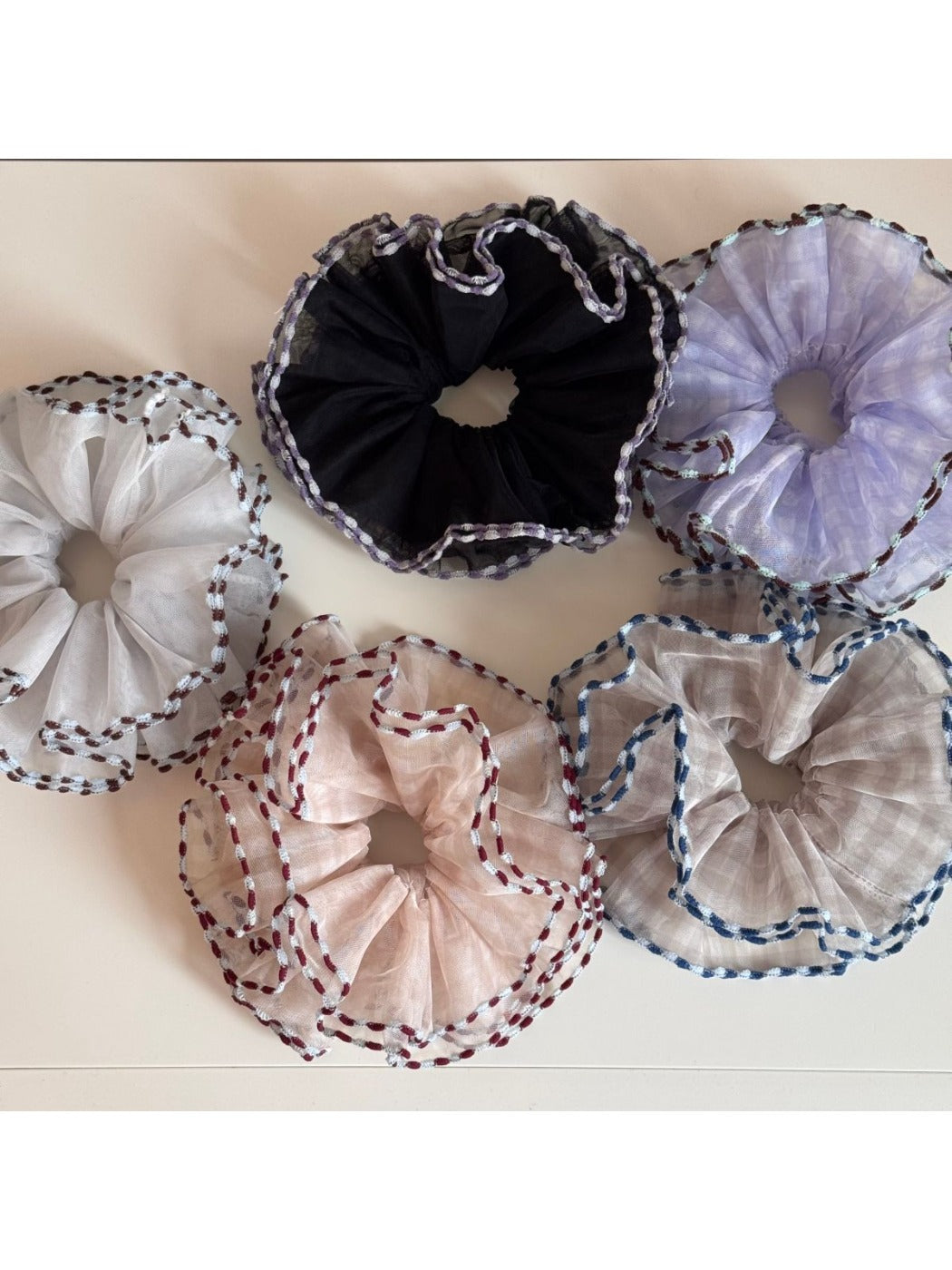 Close-up of Gifty color block tulle scrunchie with bound edges in pastel shades