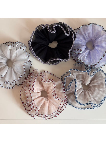Close-up of Gifty color block tulle scrunchie with bound edges in pastel shades