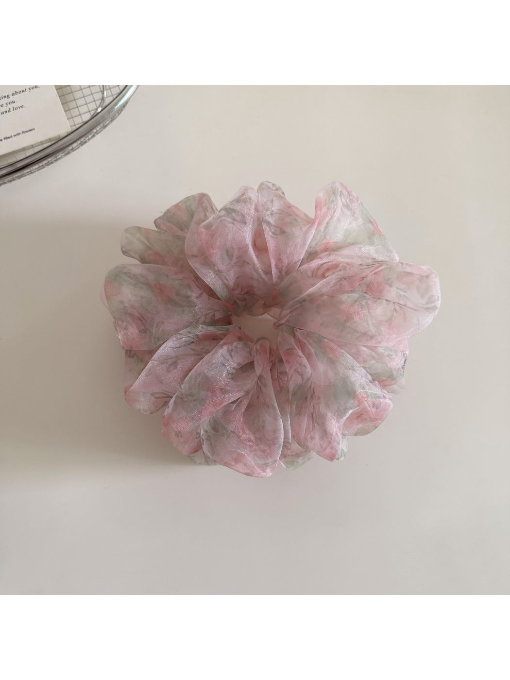 Gifty ditsy floral print hair scrunchie displayed flat with detailed flower pattern