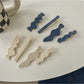 Close-up of Beau hair clip showing blue and white floral design and metal clasp