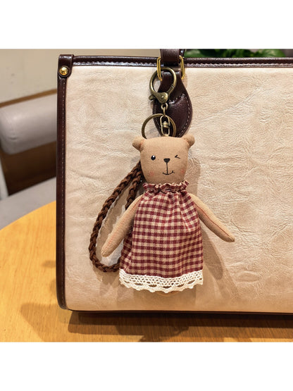 Cartoon bear charm keychain displayed on a white background with soft shadows