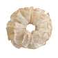 Side view of Gifty tiny floral print scrunchie highlighting fabric texture
