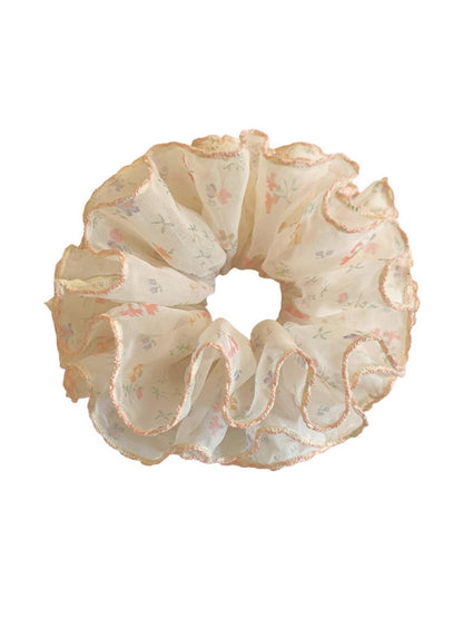 Side view of Gifty tiny floral print scrunchie highlighting fabric texture