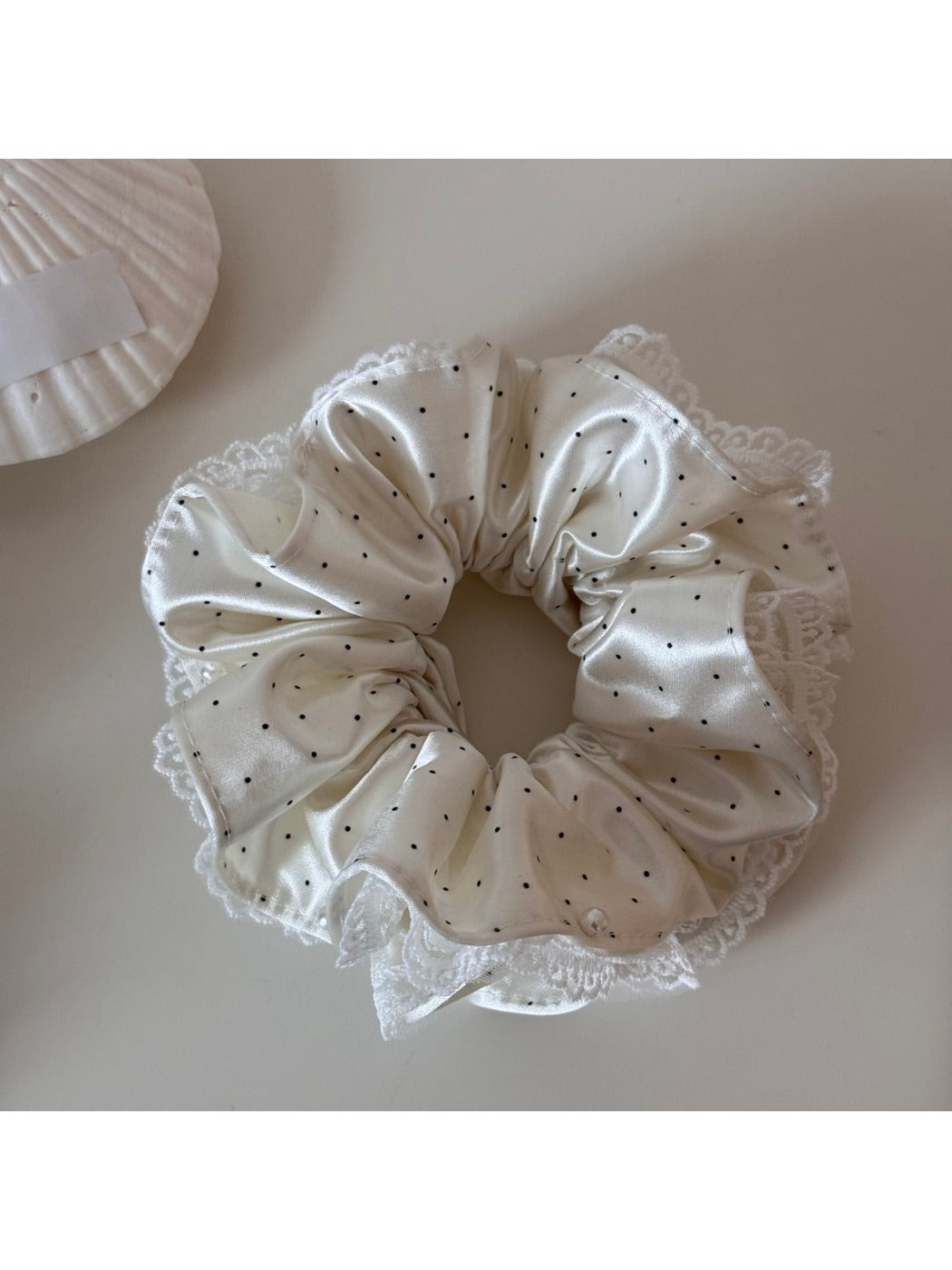 Gifty scrunchie worn on a wrist, highlighting its lightweight and colorful design