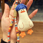 Blue duck keychain hanging from a bag zipper with visible hair strands