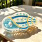 Beau claw clip in pastel green with sea animal design displayed flat