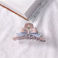 Beau acetate bow shaped claw clip shown in natural outdoor setting