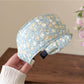 Folded cute headband showing detailed stitching and countryside floral print